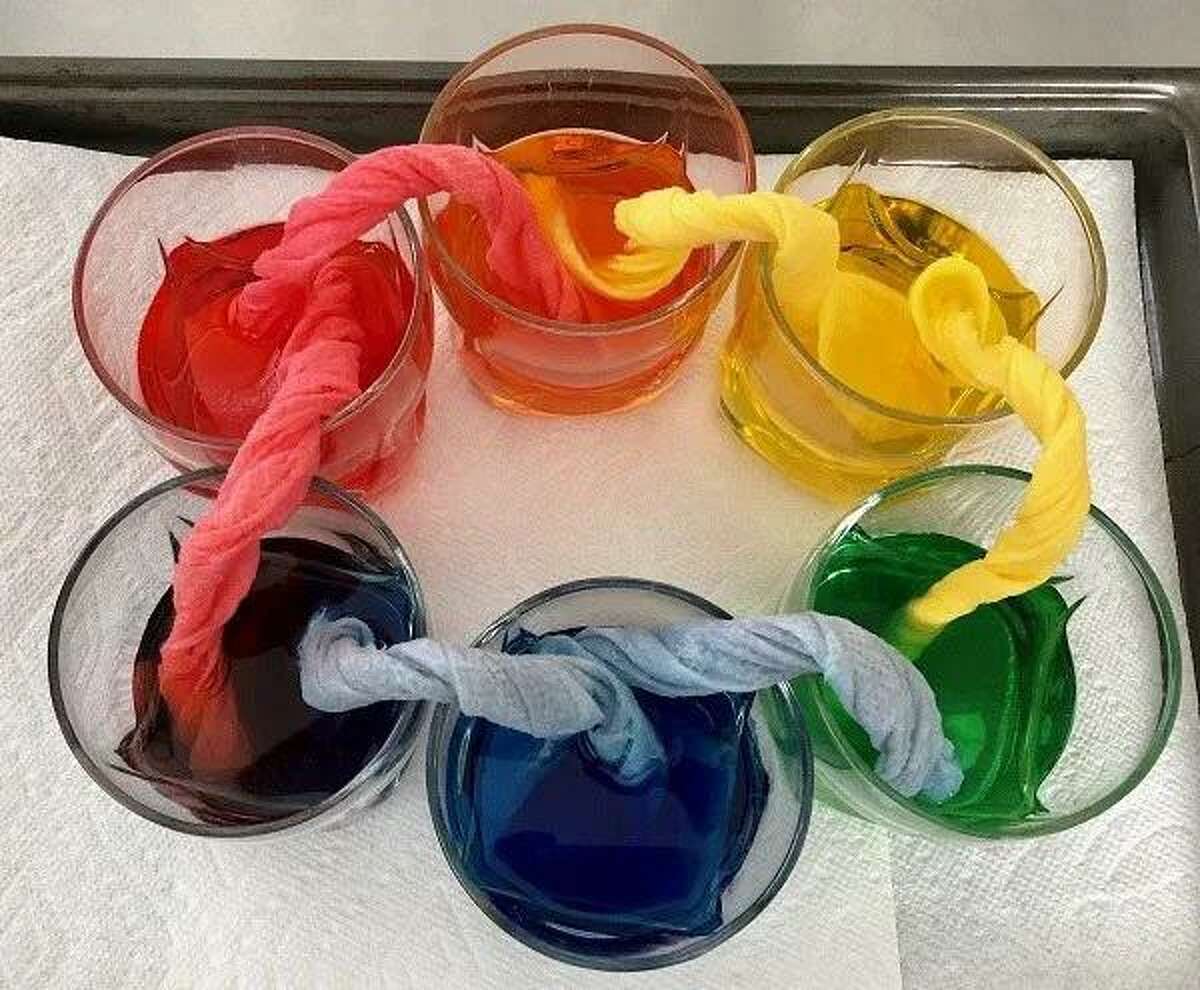 Mad Scientist Color Wheel | Pre-K kids will have fun learning about colors with this STEAM project. They will love watching the Mad Scientist Color Wheel draw from primary colors — red, blue and yellow — to create secondary colors of orange, green and purple. The bent wicks between each glass give a sense of a laboratory setting, adding to the cool factor. Little ones will love doing all the steps themselves.  
