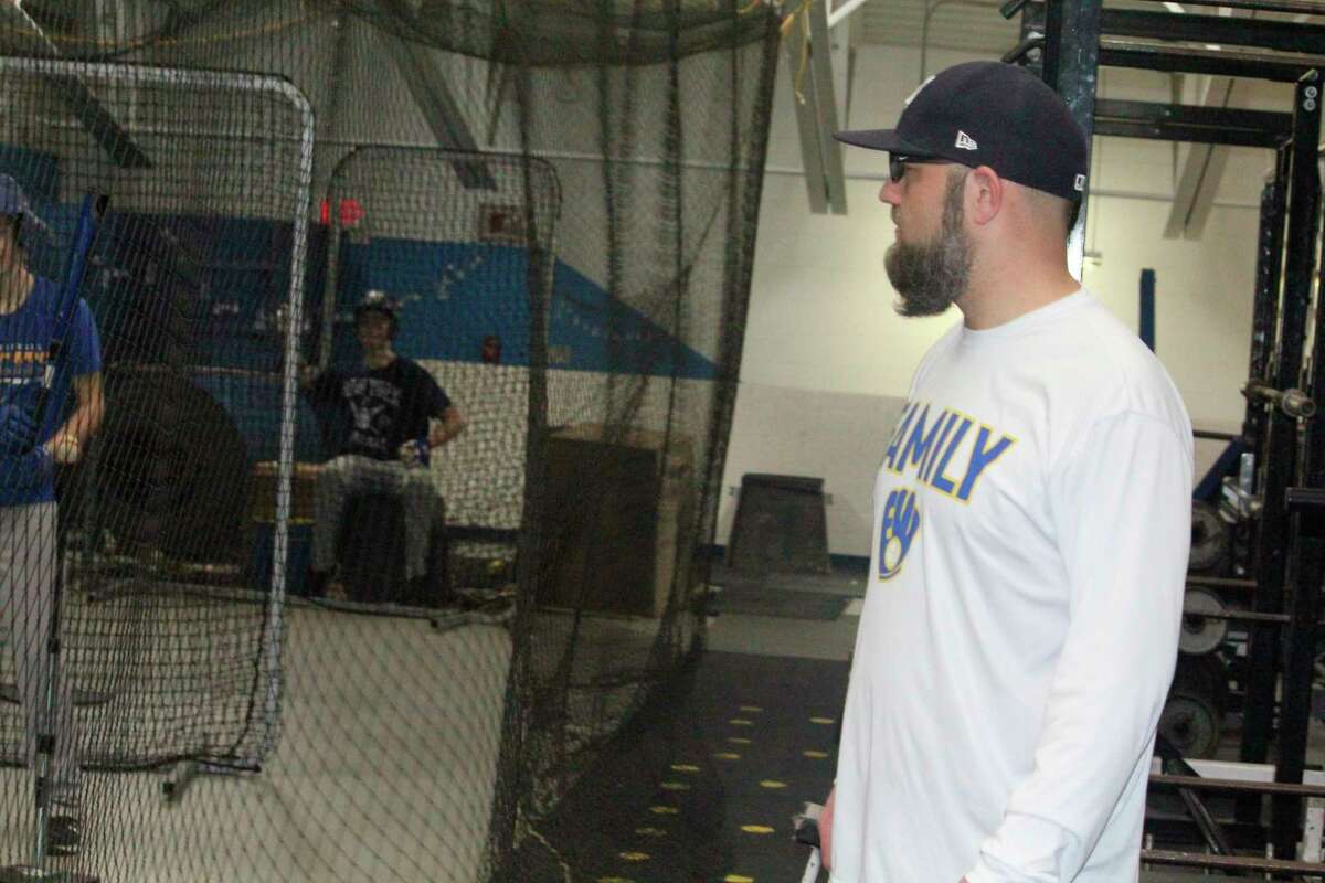 Evart baseball coach Josh Johnson watches his team during a practice on Friday night inside the Wildcat gymnasium. (Herald Review photo/John Raffel)