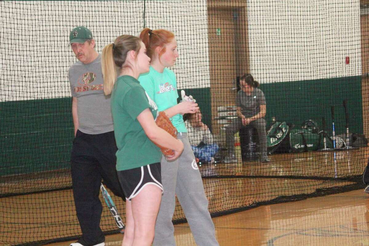Pine River softball coach Mike Nelson (left) watches his team go through a practice session on Friday. (Herald Review photo/John Raffel)
