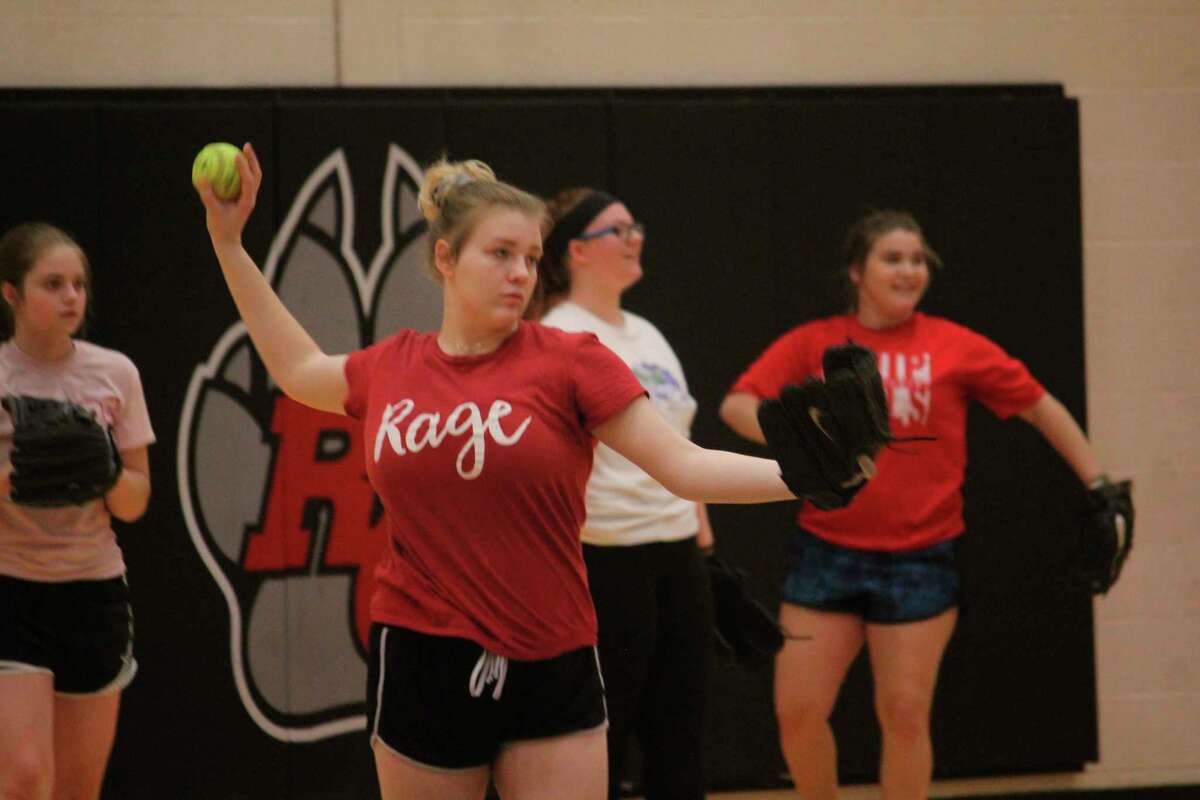 Reed City softball senior Cassie Enos warms up her arm during a practice last week. (Herald Review photo/John Raffel)