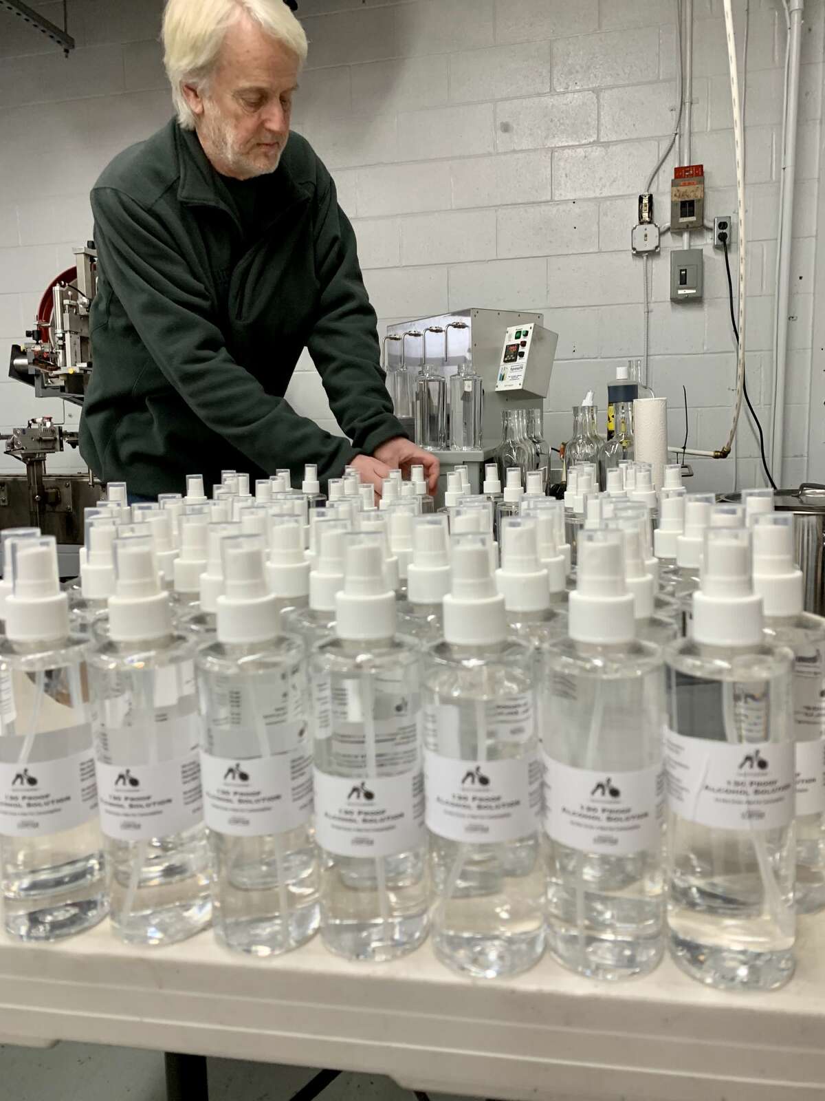 David Baker, co-owner of Litchfield Distilleries in Litchfield, Conn. bottles alcohol spray.