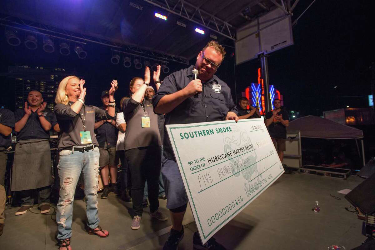 Chris Shepherd holds a $500,000 check for Hurricane Harvey relief at Southern Smoke 2017.