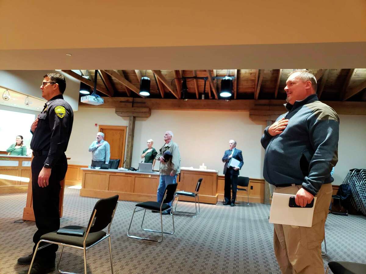 Manistee City Councilmembers and audience members alike sat, stood and presented six feet apart Tuesday evening. Attendees are pictured reciting the Pledge of Allegiance. (Arielle Breen/News Advocate)
