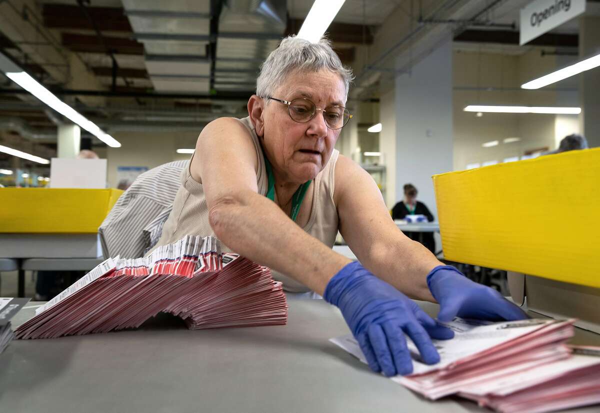 RENTON, WASHINGTON - MARCH 09: An election worker wearing protective gloves sorts through mailed-in ballots in the King County Elections ballot processing center on March 09, 2020 in Renton, Washington. Election officials mandated wearing gloves in this year's primary election counting process, as a protective measure. King County has had the highest number of deaths in the U.S. due to the coronavirus outbreak. (Photo by John Moore/Getty Images)