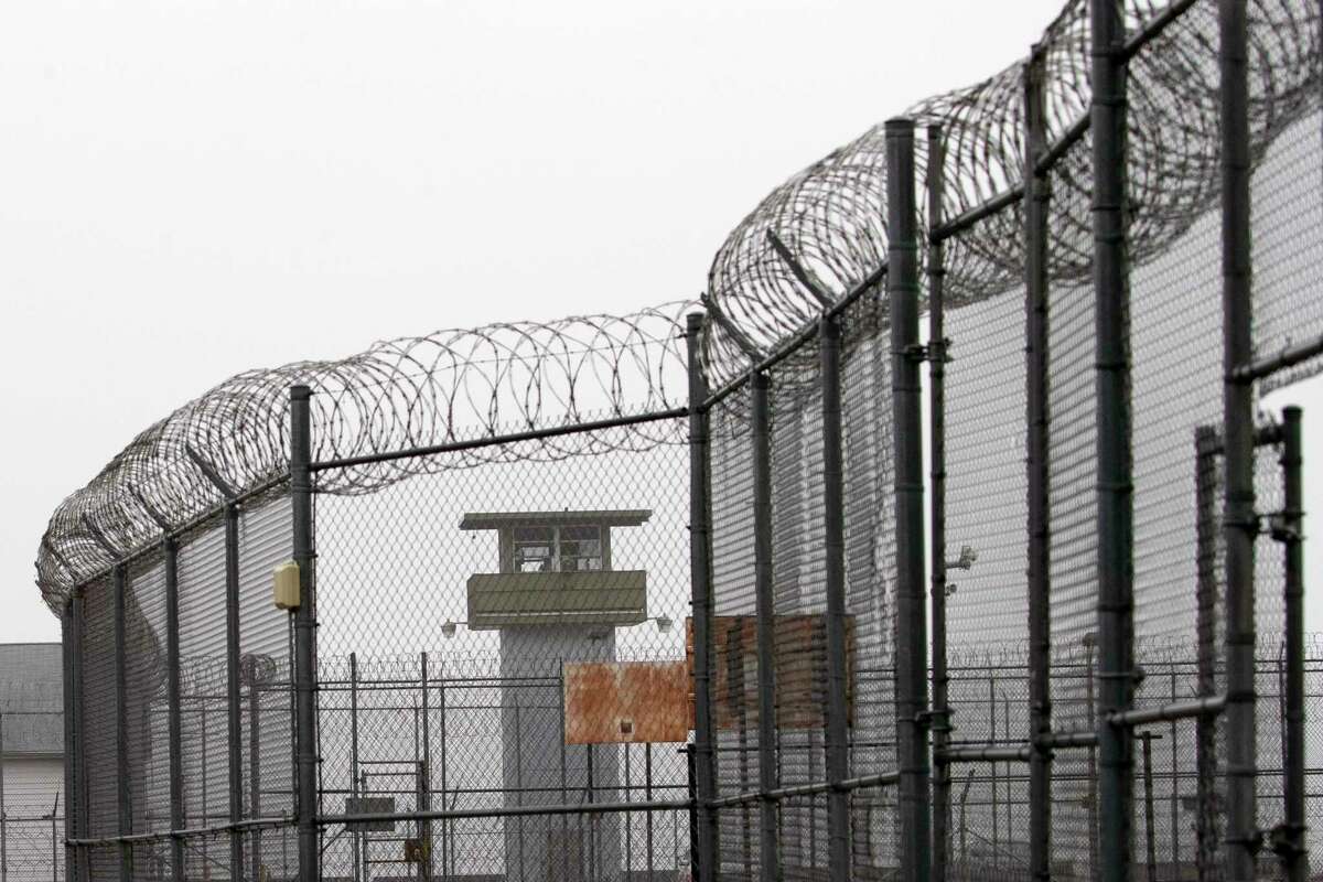 A guard tower and barbed wire fencing stand outside Sing Sing, Sunday, Feb. 16, 2020 in Ossining, N.Y. Busting out of Sing Sing has been a dream of inmates since cell doors started clanging shut along the Hudson River in the 1820s. Now there's a plan to usher visitors inside the high walls of the prison famous as a go-to destination for gangsters, Hollywood stars and inmates condemned to the electric chair. (AP Photo/Mark Lennihan)
