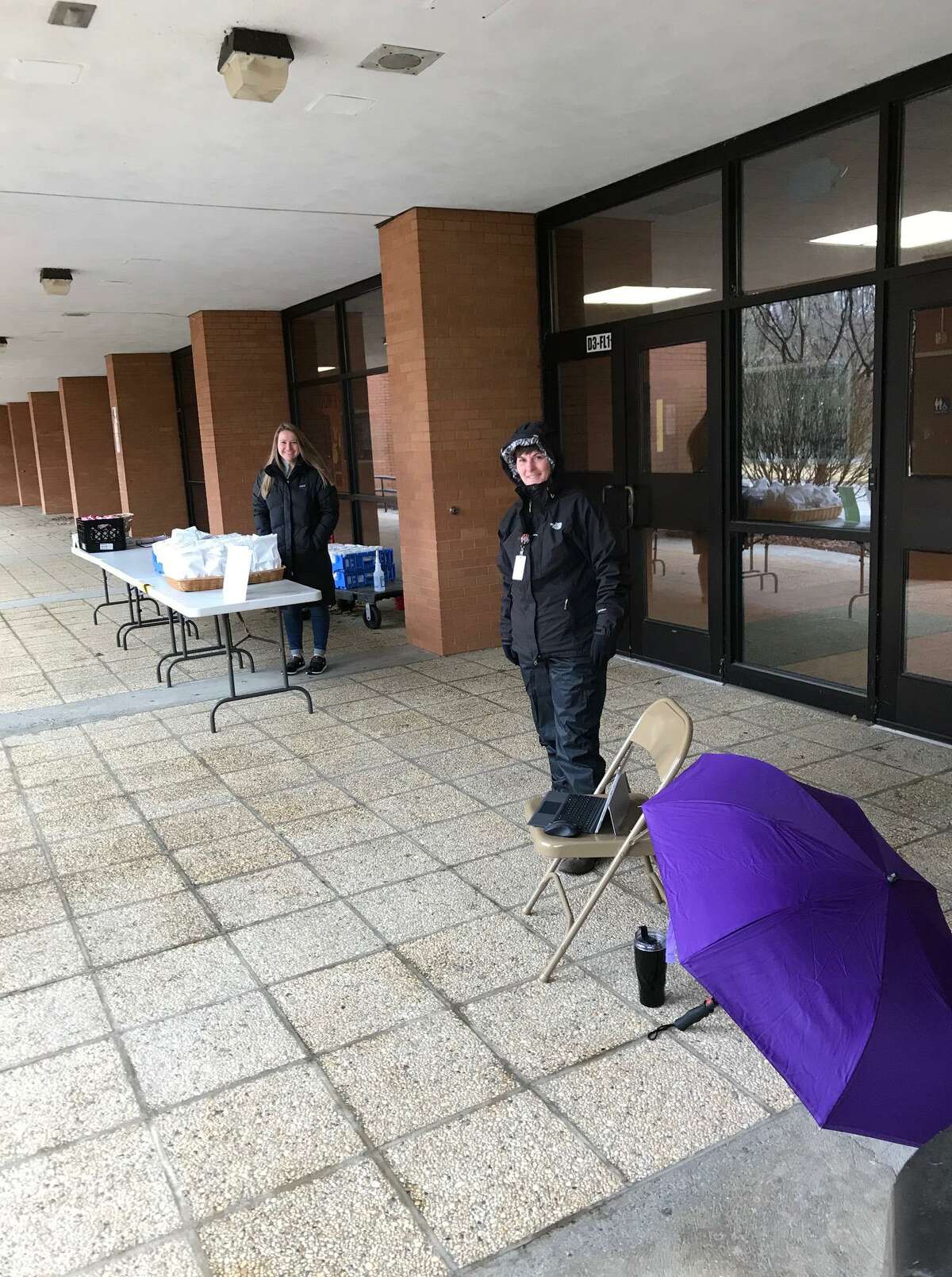 Interim Superintendent Beth Smith dons her rain gear Thursday, March 19, and is ready to distribute food to families at Shelton High School.