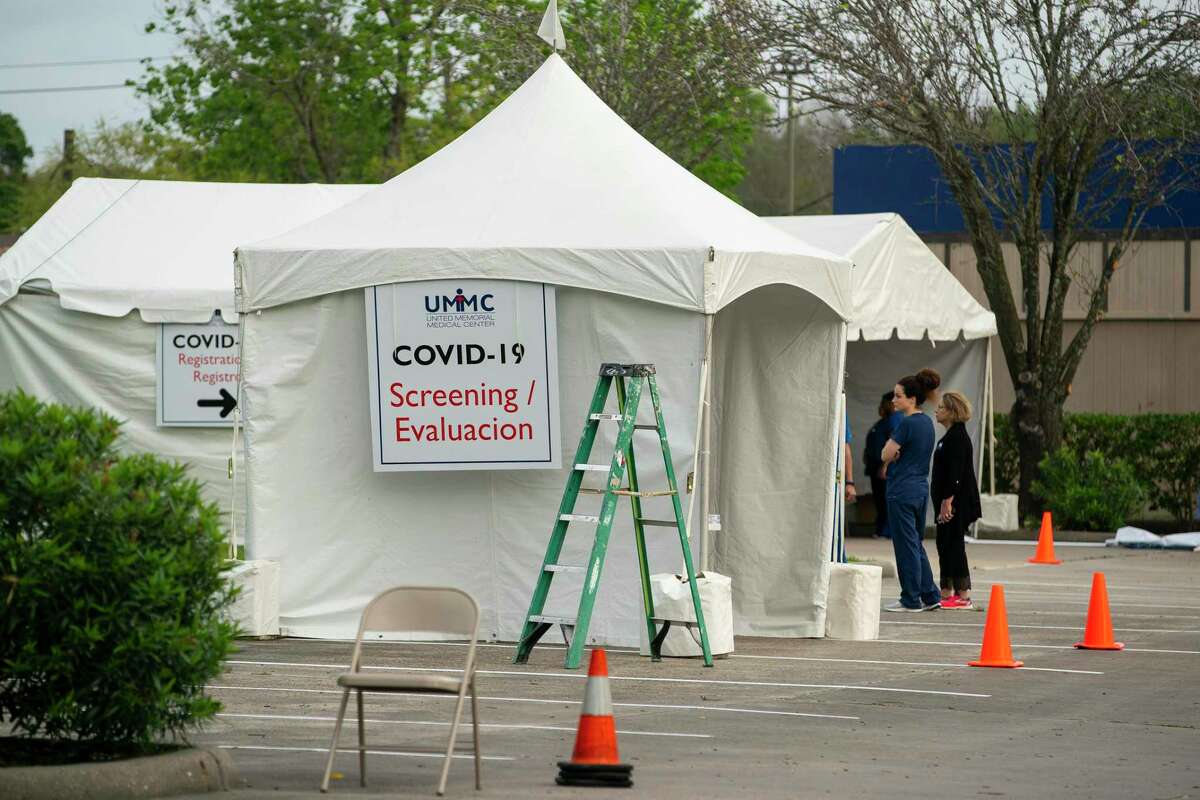 People wait in line to be screened and possibly tested for Covid-19 in a line that extends east on W. Tidwell and north onto Yale Street, Thursday, March 19, 2020, at the United Memorial Medical Center in Houston.
