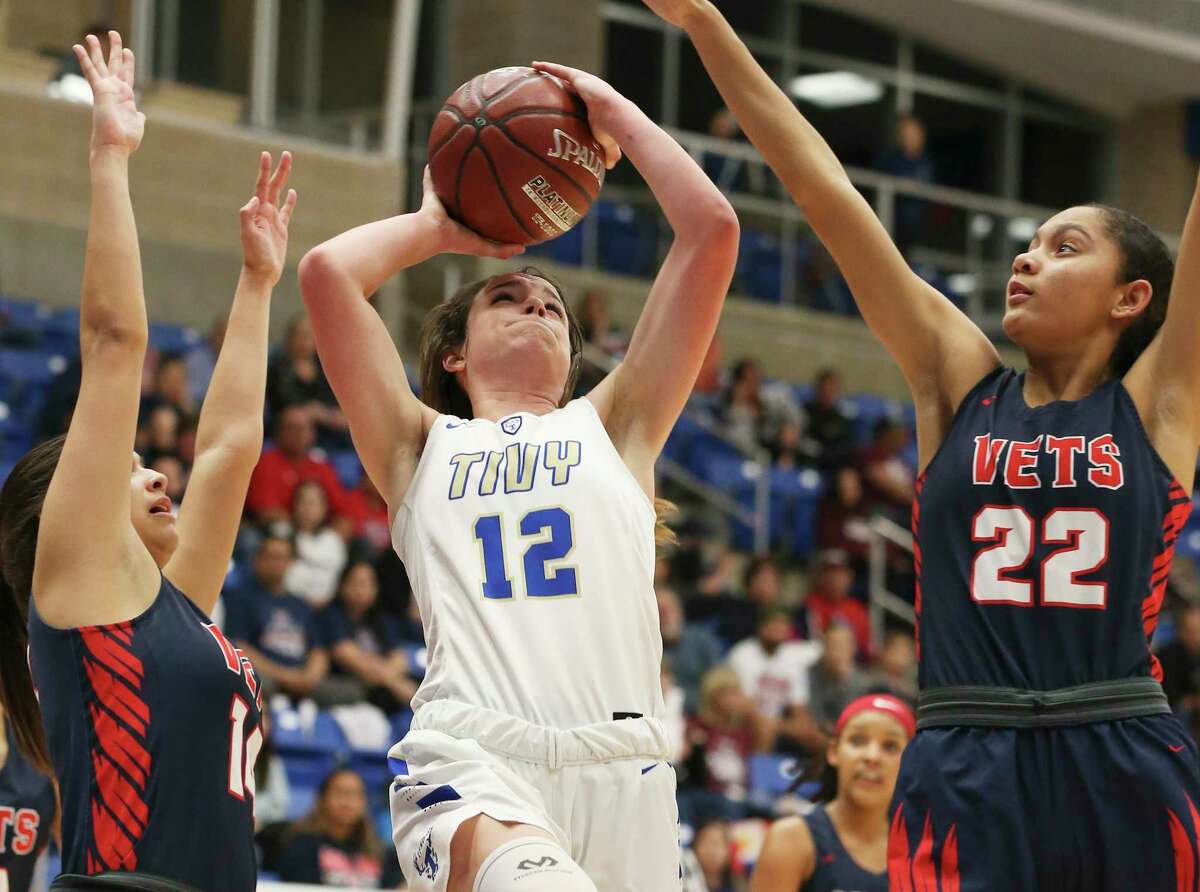 Kerrville Tivy's Audrey Robertson (12) attempts a shot against Corpus Christi Veterans Memorial's Samantha Perez (14) and Tatiana Mosley (22) during their Region IV-5A semifinal game on Friday, Feb. 28, 2020. Tiny defeated CC Veterans Memorial, 59-55, to advance to the regional final.