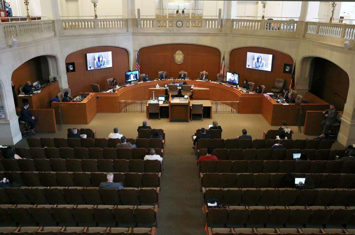 The view from above shows the efforts to maintain social distance and the attendance restriction to no more than 50 people at council chambers as Mayor Ron Nirenberg and the City Council gather to discuss extending the latest Coronavirus emergency declaration to 30 days on Thursday, Mar. 19, 2020. Two council members: District 8's Manny Peláez and District 3's Rebecca J. Viagran were present via video-conferencing since both are self-quarantining from their homes. The meeting was held under attendance restriction on no more than 50 people and seating in the room observed social distancing with signage included.