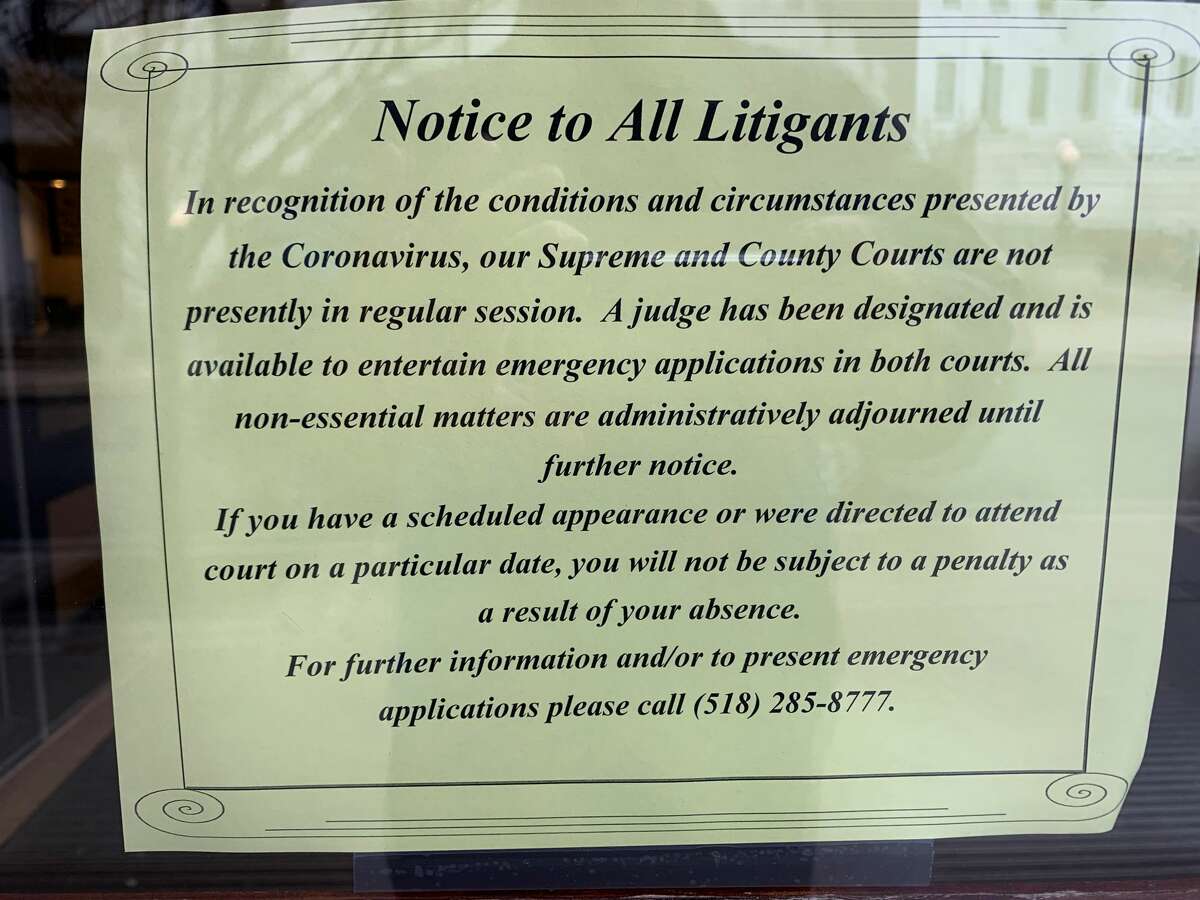 Sign notifies litigants that state Supreme Court and Albany County Court are “not presently in session.” The website of the state's Unified Court System says court is being held at the Court of Claims.