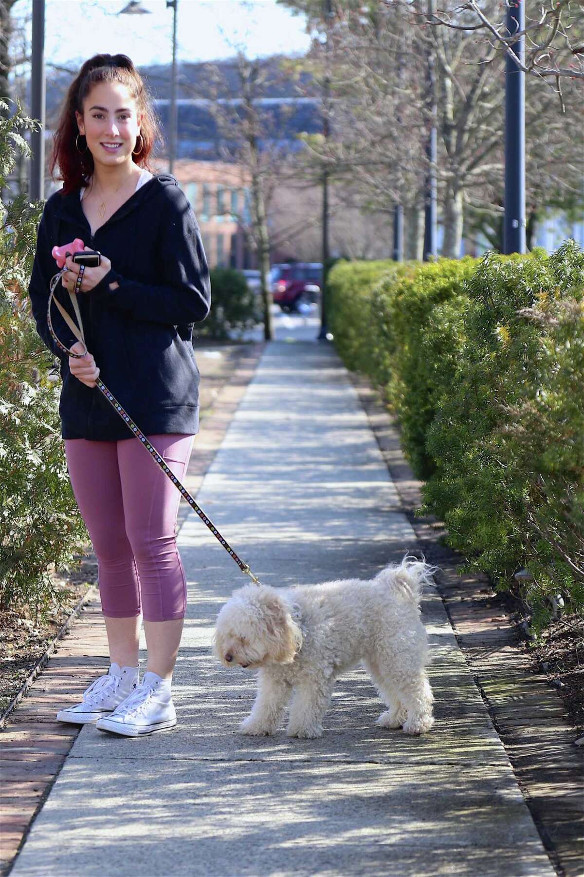 Zara Wiest of Wilton is glad to get out on a nice day with her dog Hazel on Friday.