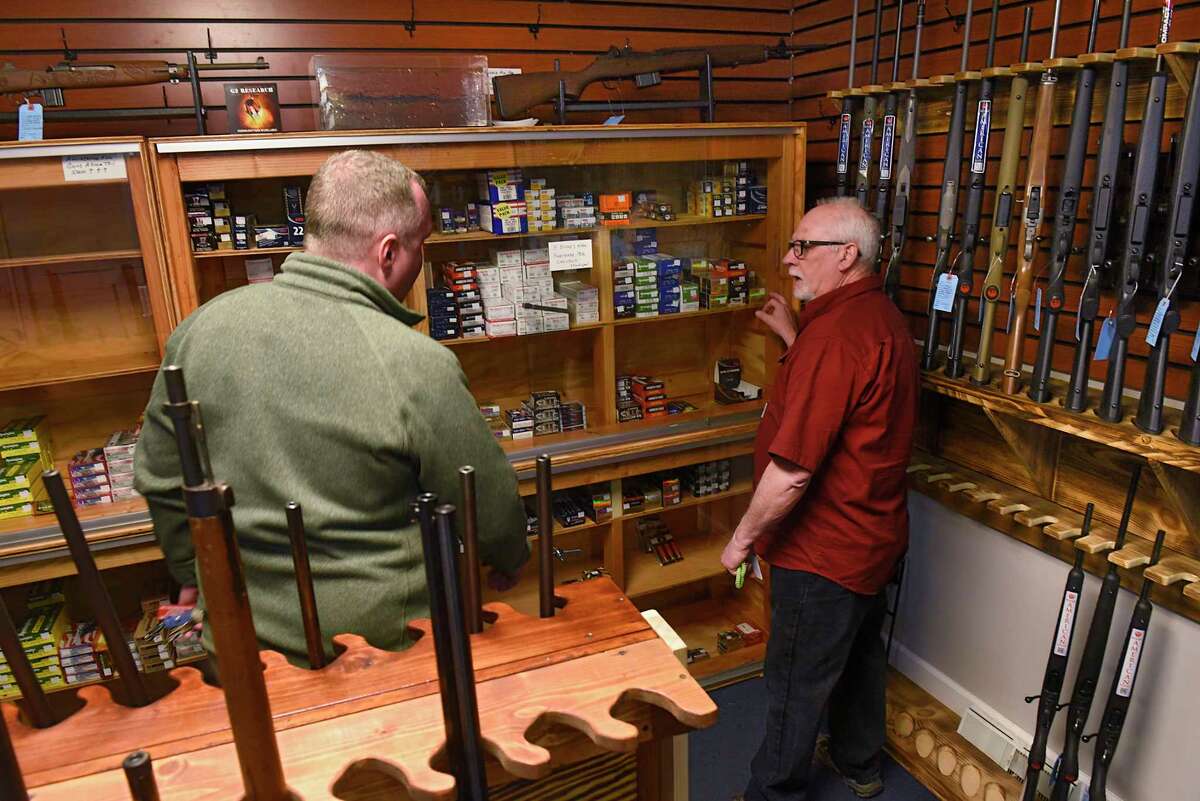 Employee Jim Retajczyk, right, retrieves ammunition for James of Latham (he didn't want to give his last name) a customer at Upstate Guns & Ammo store on Thursday, March 19, 2020 in Schenectady N.Y. (Lori Van Buren/Times Union)