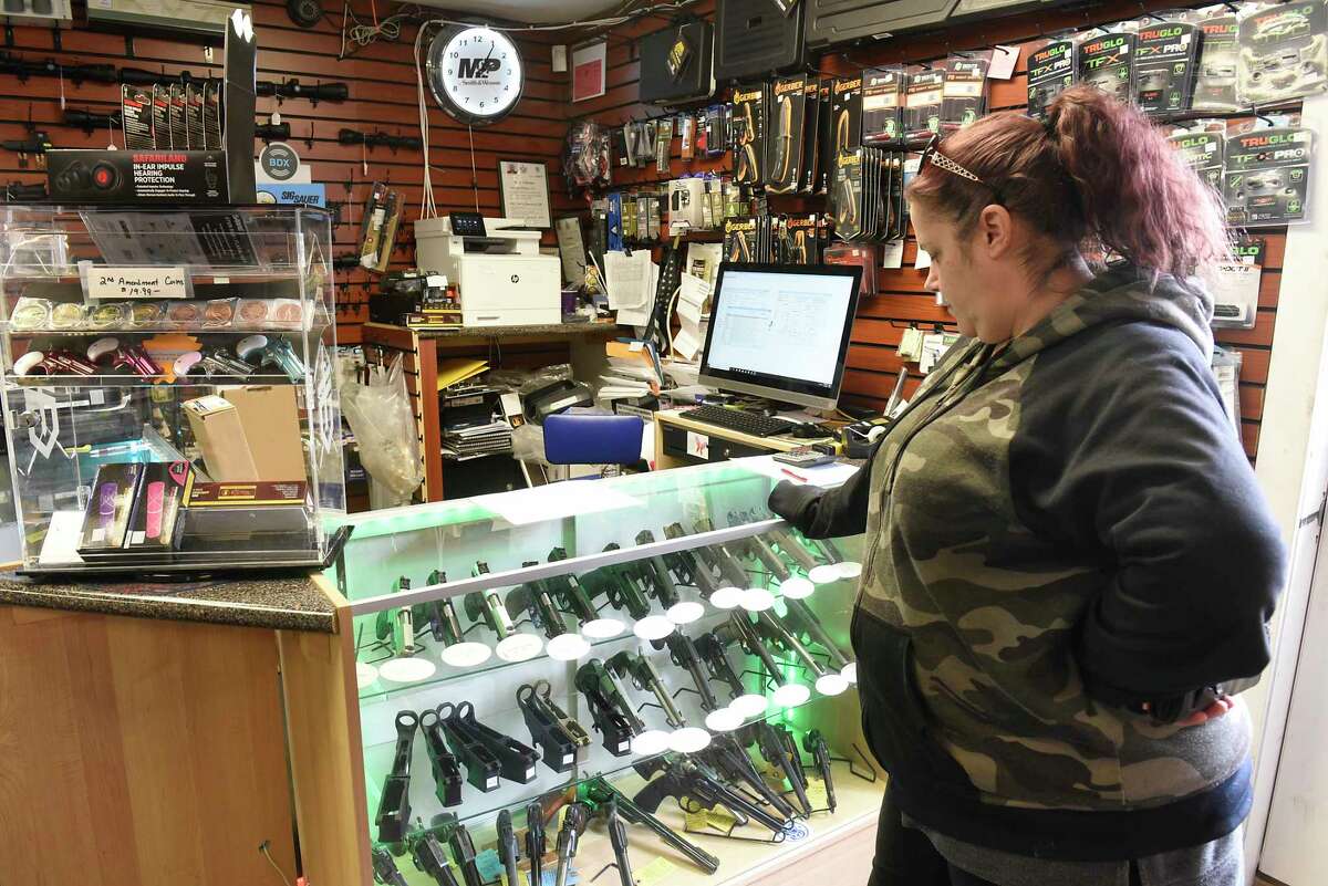 Michelle Kern of Rotterdam looks at pistols as she waits to buy ammunition for hunting at Upstate Guns & Ammo store on Thursday, March 19, 2020 in Schenectady, N.Y. (Lori Van Buren/Times Union)