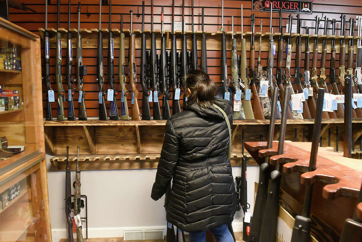 Customer Christina Deonauth of Schenectady shops for rifle for protection at Upstate Guns & Ammo store on Thursday, March 19, 2020 in Schenectady, N.Y. (Lori Van Buren/Times Union)
