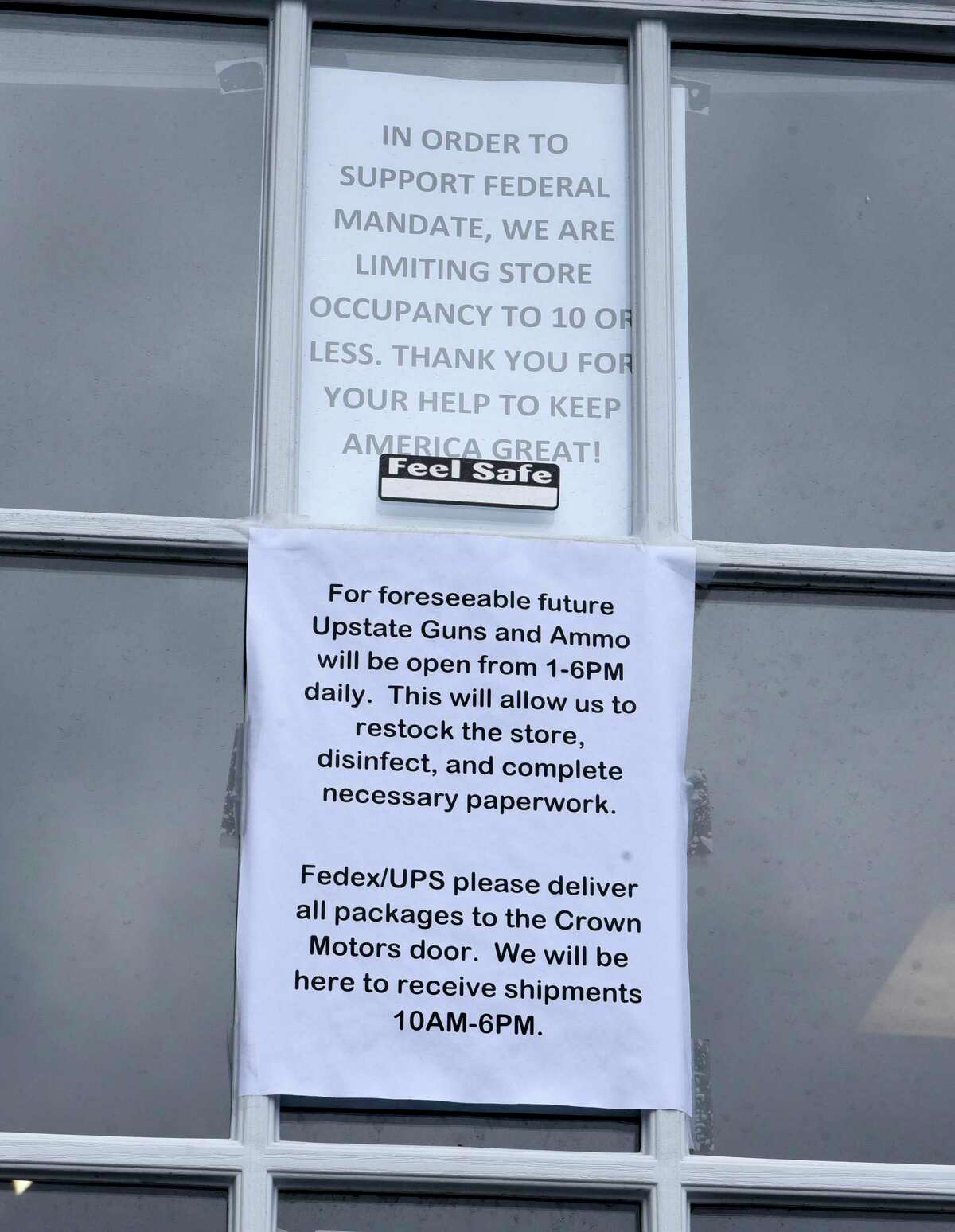 Compliance signs are posted on the door to keep up with mandates at Upstate Guns & Ammo store on Thursday, March 19, 2020 in Schenectady N.Y. (Lori Van Buren/Times Union)