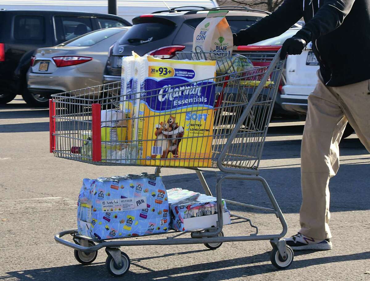Almost every cart had toilet paper in it as customers leave BJ's Wholesale Club on Wednesday, March 18, 2020 in Colonie, N.Y. (Lori Van Buren/Times Union)