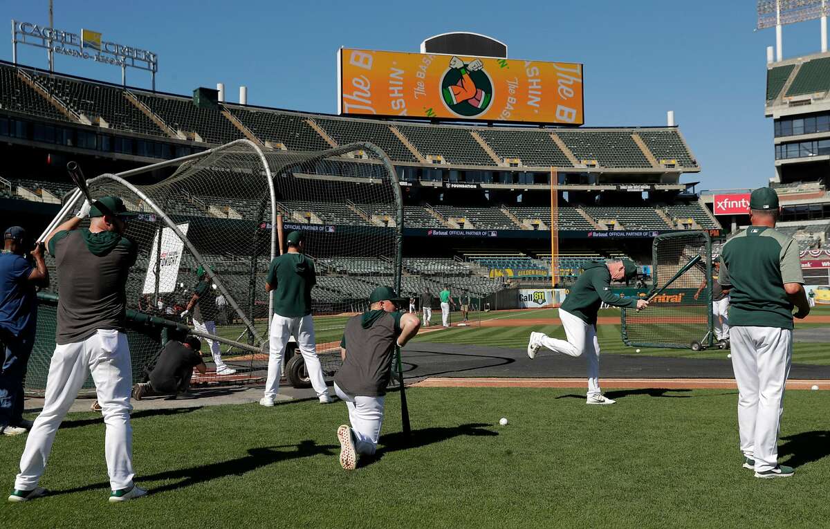 Oakland A's players warm up before the Oakland Athletics played the Tampa Bay Rays at the Oakland Coliseum in the Wild Card playoff game in Oakland, Calif., on Wednesday, October 2, 2019.