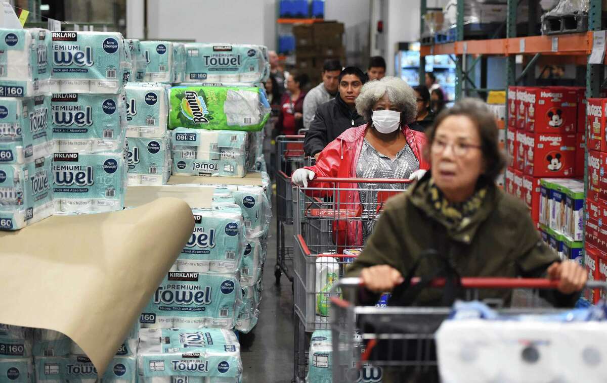 In this file photo a line of shoppers wait to buy toilet paper at a Costco store in Novato, California on March 14, 2020. 