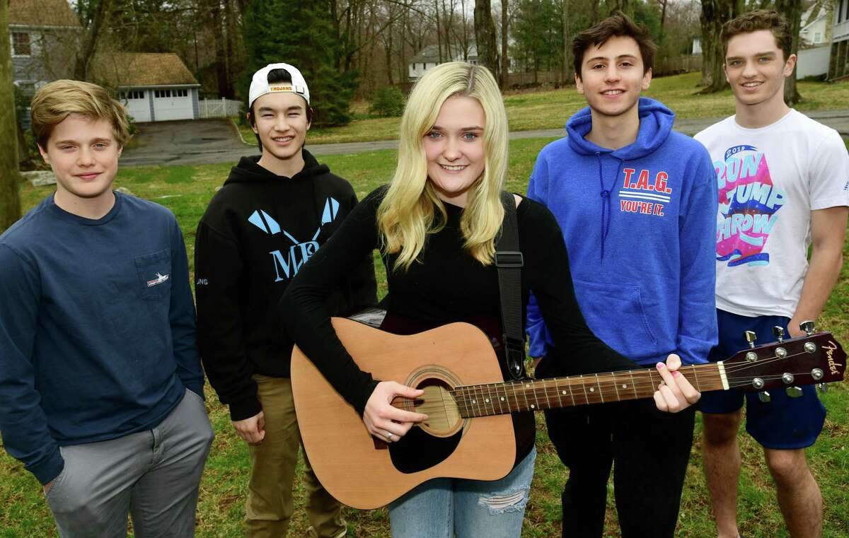 Will Holleman, Ty Chung, Clara Holleman, Will Matar and Jonathan Lorenz otherwise known as the helping guys Thursday, March 19, 2020, in Westport, Conn. The group does good deeds around town and recently sung a song for an elderly resident.