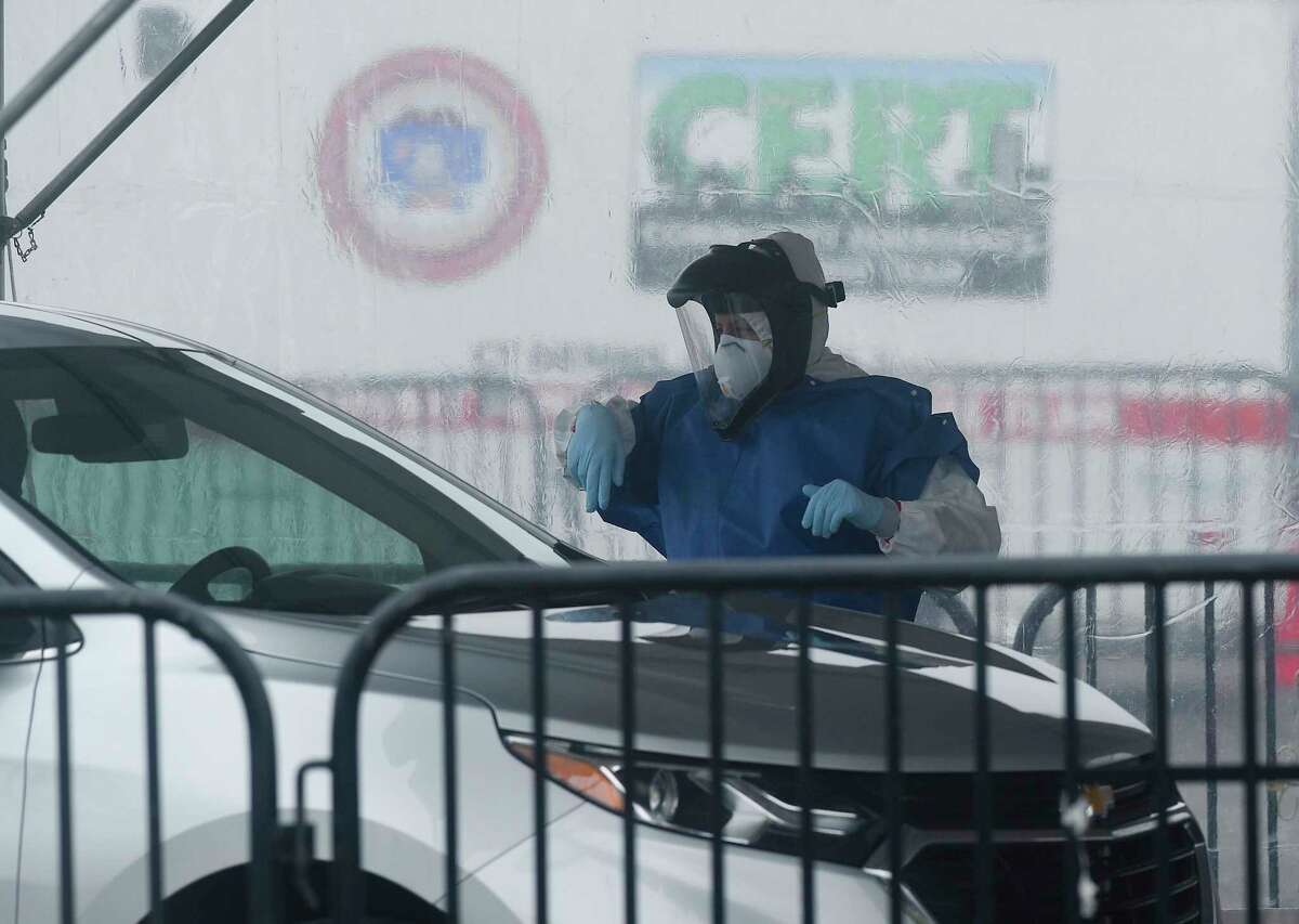 Medical personnel from Murphy Medical Associates administer drive-thru screenings for the Covid-19 coronavirus at a mobile testing site set up at Cummings Beach in Stamford, Conn. , March 20, 2020.