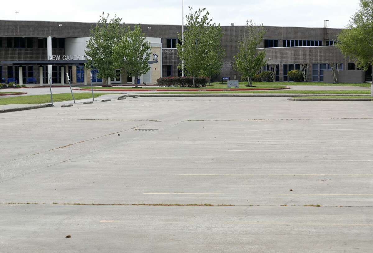An empty parking lot is seen at New Caney High School, Thursday, March, 19, 2020, in New Caney.
