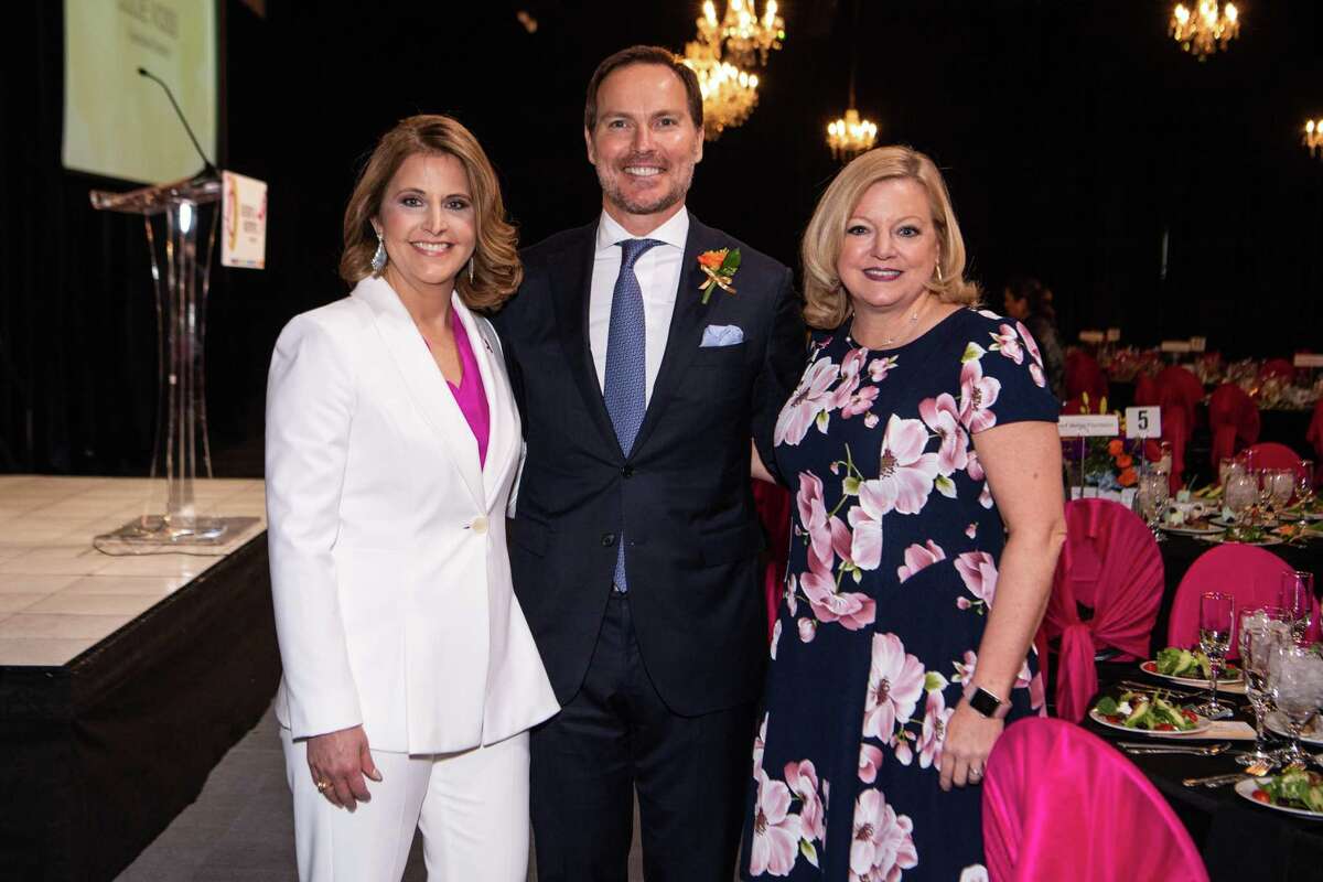 Event Co-chairs Carrie and Jonathan Brinsden, from left, and Julie Voss, Susan G. Komen Houston executive director, celebrate 30 years of the nonprofit’s fighting breast cancer in the greater Houston area at the More than Pink luncheon on March 6 at the Ballroom at Bayou Place in downtown Houston.