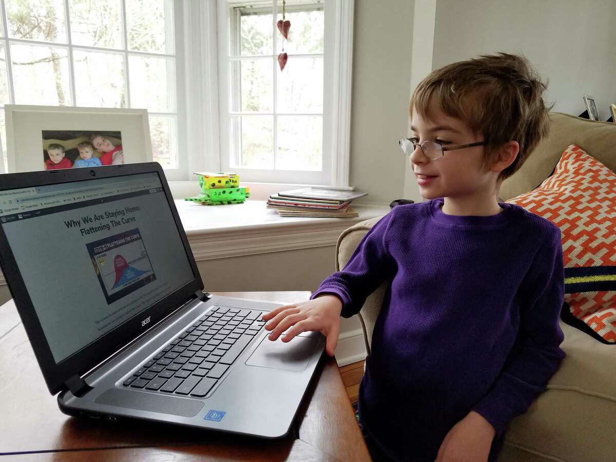 Ryland Hunt, 9, works on his website, “Ryland’s Newspaper,” on a computer at home
