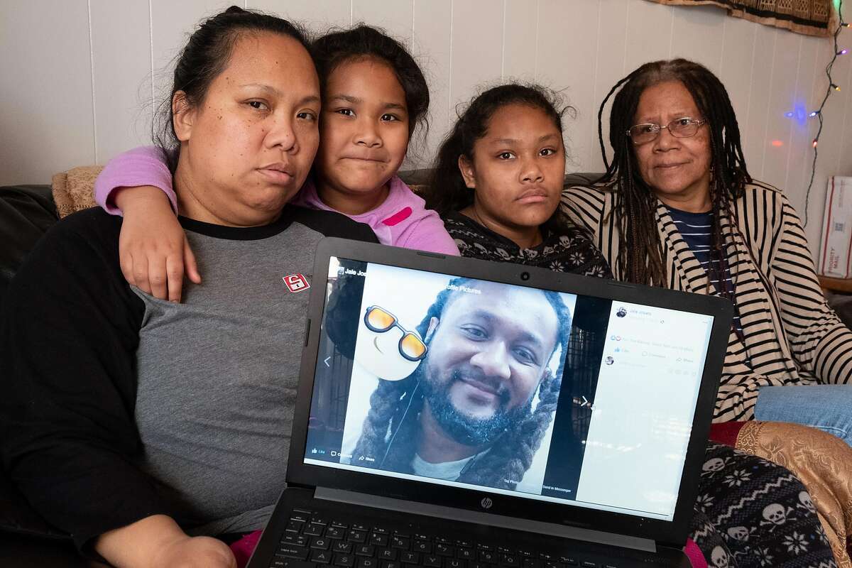 The family of Charles Joseph � his wife Shelly Clements, daughters Carly, 7, and Hope, 12, and his mother Alumita Siva, display a photo of him on a Facebook page in their apartment in Sacramento, Wednesday, January 29.