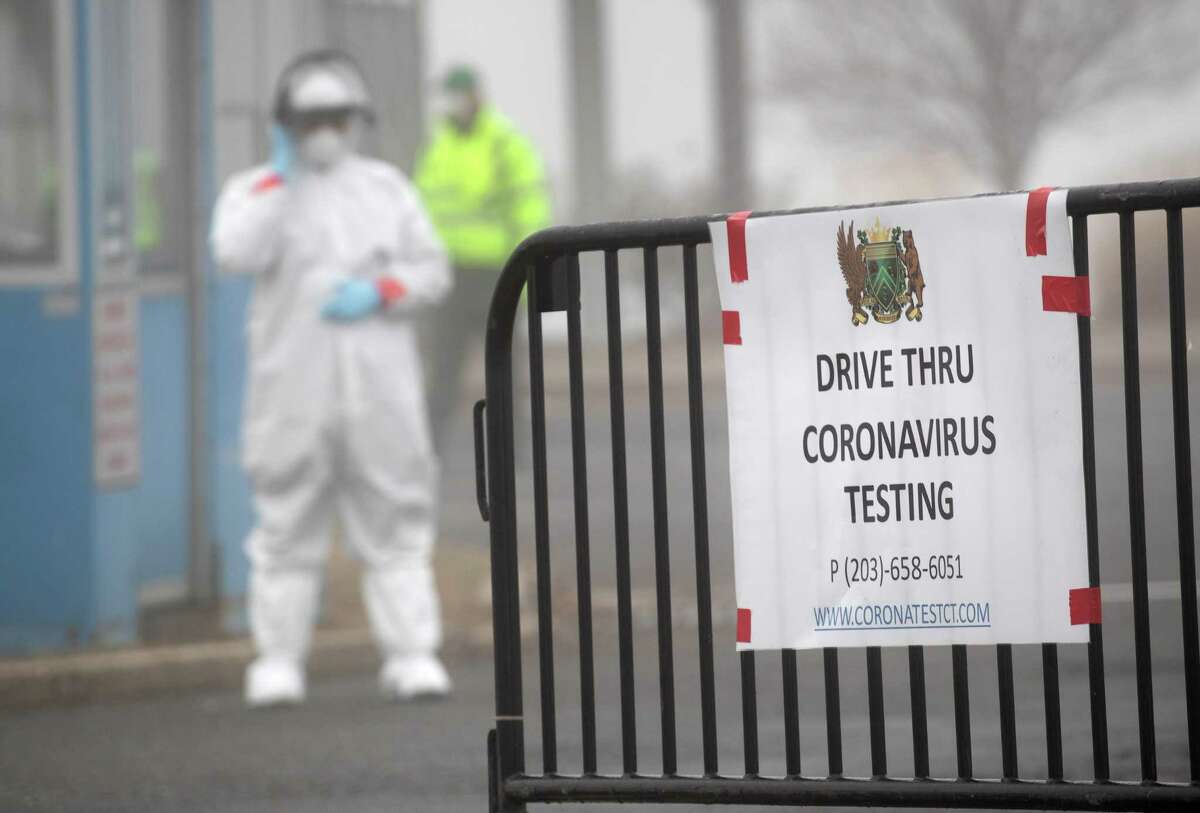 A sign sits on a barrier at a coronavirus (COVID-19) drive thru testing location operated by Murphy Medical Associates at Cummings Park on March 20 in Stamford. Communities throughout the United States have begun opening drive-thru sites to test people feeling potential symptoms of COVID-19 and have a doctor’s referral.