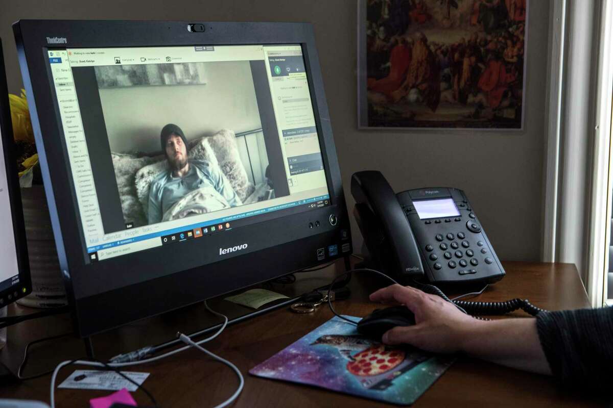 Cancer patient Austin Bond is ministered to by lay chaplain Dawn Malone via video conference on Thursday, March 19, 2020 in Houston. Coronavirus has limited local chaplains the ability to minister to the sick or elderly. Chaplains have also been told not to minister to any group more than 10.