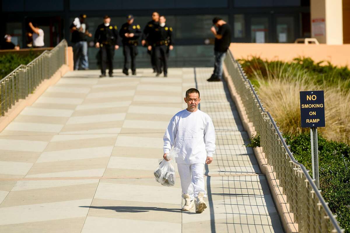 I Vuai carries his belongings as he leaves Santa Rita Jail on Friday, March 20, 2020, in Dublin, Calif. He was one of several hundred prisoners granted early release as the county tries to prevent coronavirus spread in a vulnerable population.