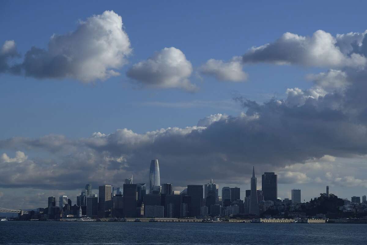 Clouds form above the San Francisco skyline in this view from a Golden Gate Ferry Monday, March 16, 2020, in San Francisco. Officials in seven San Francisco Bay Area counties have issued a shelter-in-place mandate affecting about 7 million people, including the city of San Francisco itself. The order says residents must stay inside and venture out only for necessities for three weeks starting Tuesday. It's the latest effort by officials to curb the spread of the novel coronavirus. (AP Photo/Eric Risberg)