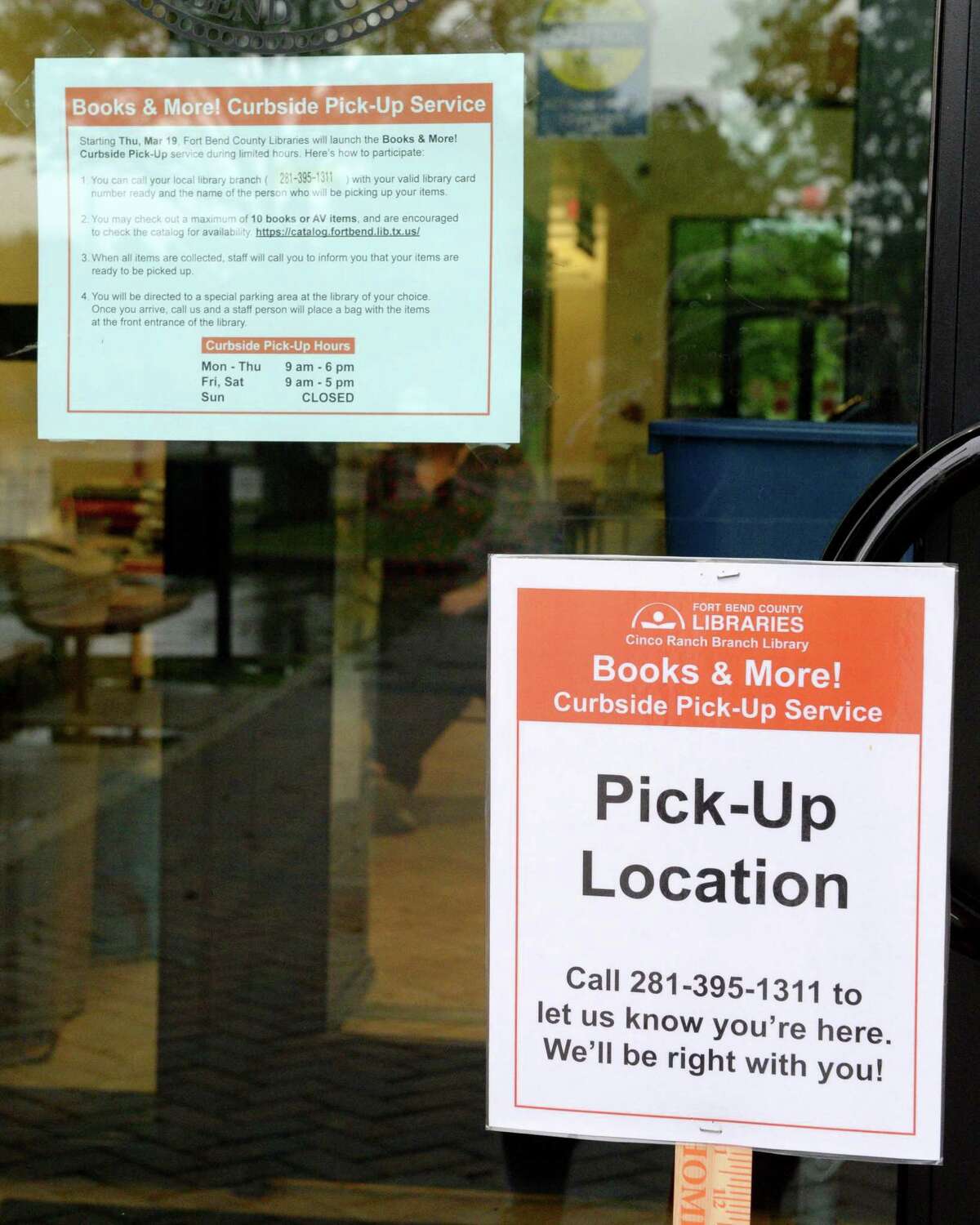 Signs notifying patrons of curbside pickup options at the Fort Bend County Library, Cinco Ranch Branch, Katy, TX on Friday, March 20, 2020. Library officials recently announced curbside pick-up services were being canceled for at least weeks.