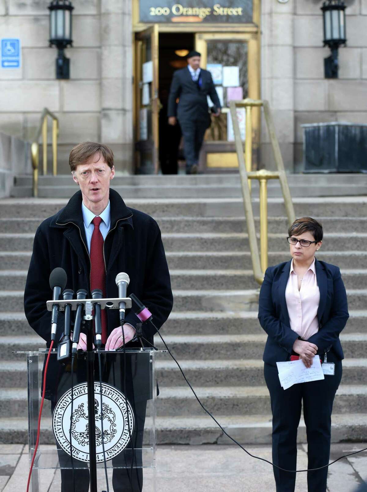 New Haven Mayor Justin Elicker holds a press briefing outside of the Hall of Records in New Haven on March 20, 2020. At right is New Haven Director of Health Maritza Bond.