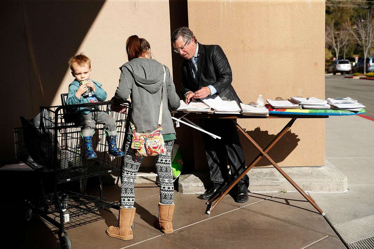 Collecting signatures outside of a Safeway grocery store in Novato, Calif., on Wednesday, February 5, 2020.