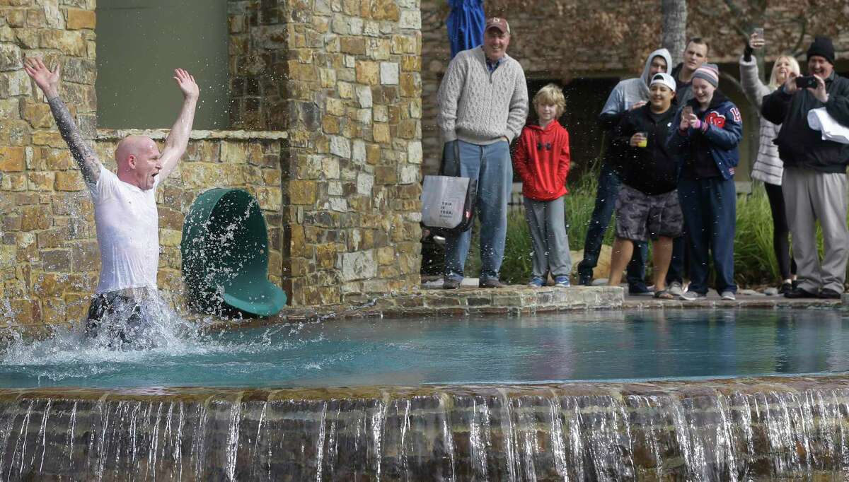 Bastian Gabriel, director of rooms, splashes into the pool after using a water slide to be the first to take the Polar Bear Plunge during event at The Woodlands Resort, 2301 N. Millbend Dr., Monday, Jan. 1, 2018, in The Woodlands. The economic fallout continued Friday from the new coronavirus with The Woodlands Resort and two other Howard Hughes Corp.-owned hotels in The Woodlands closing effective Sunday afternoon until July 1.