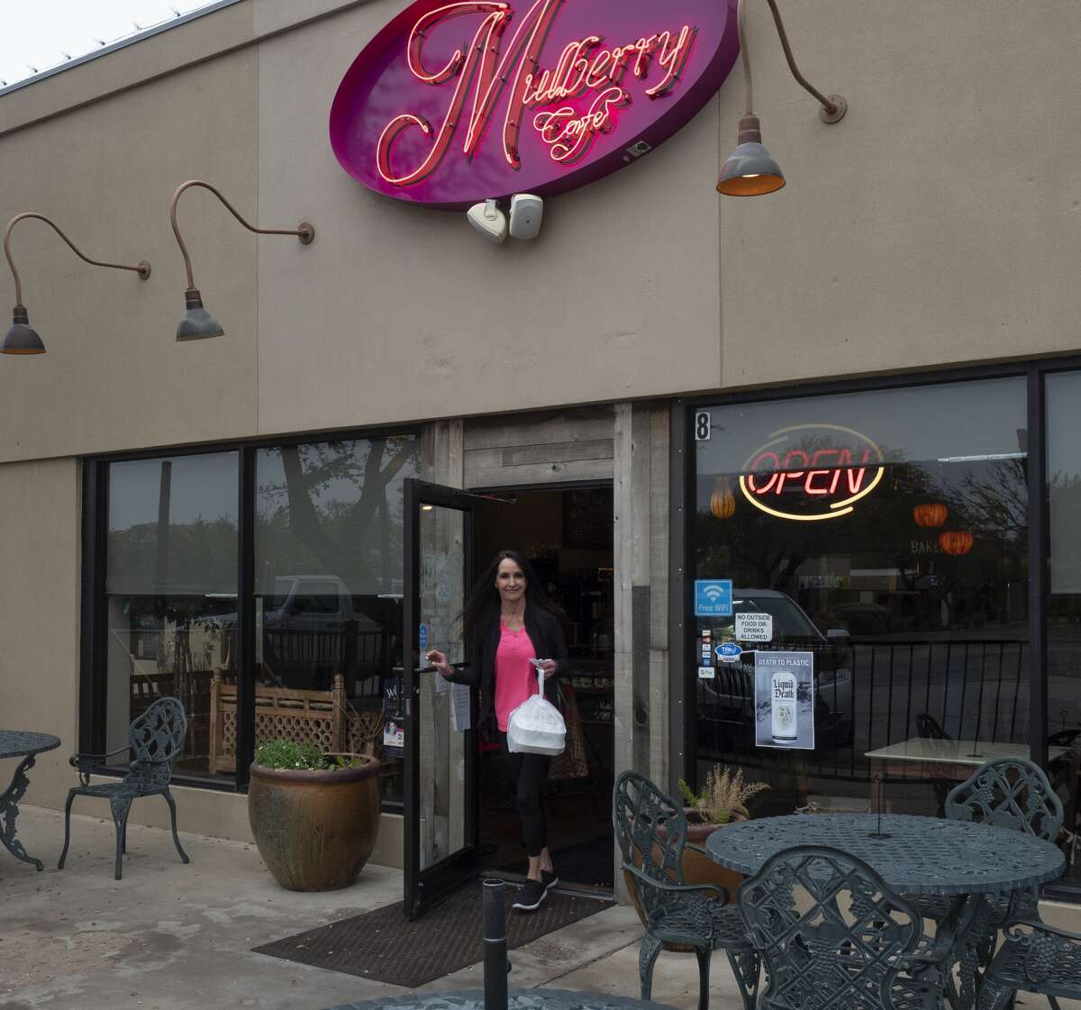 Priscilla Lowery picks up a to-go order 03/21/2020 at Mulberry Cafe as the seating area is closed. Tim Fischer/Reporter-Telegram