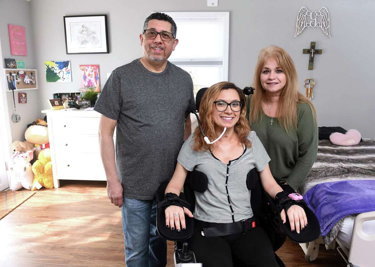 Gabby Murillo, center, is photographed in the addition to her home with her parents, Eric and Amanda, in West Haven on March 15, 2020.