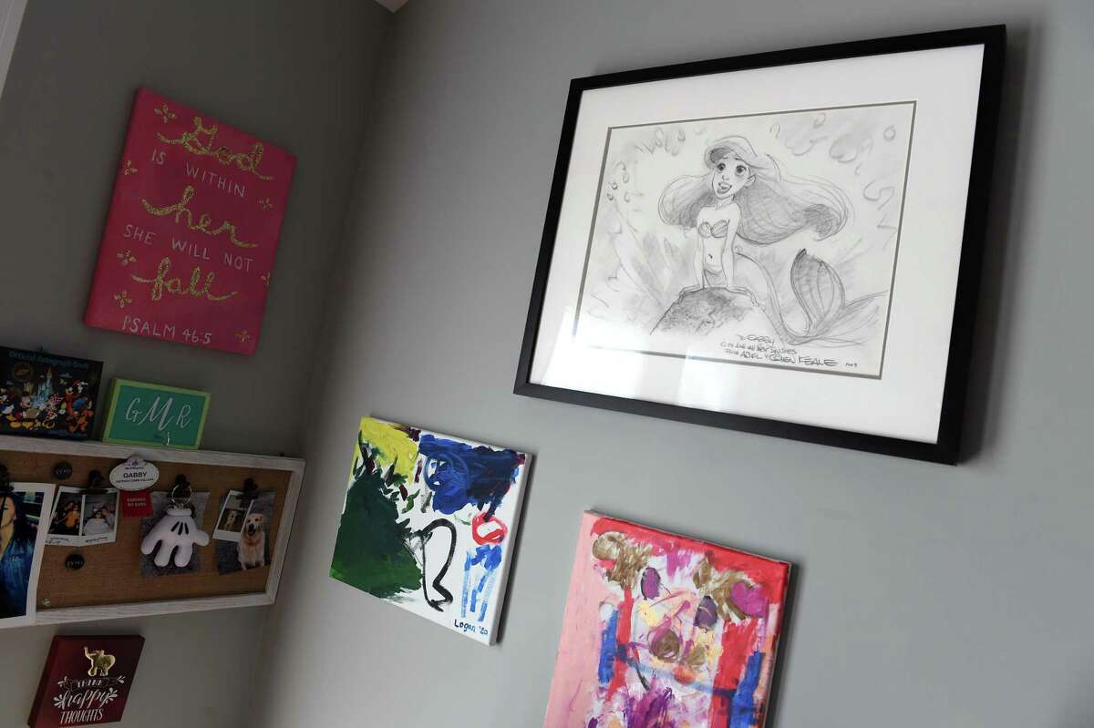 A drawing of the Disney character, Ariel, right, from “The Little Mermaid” hangs with other artwork on the wall in the addition to Gabby Murillo’s home in West Haven on March 15, 2020.