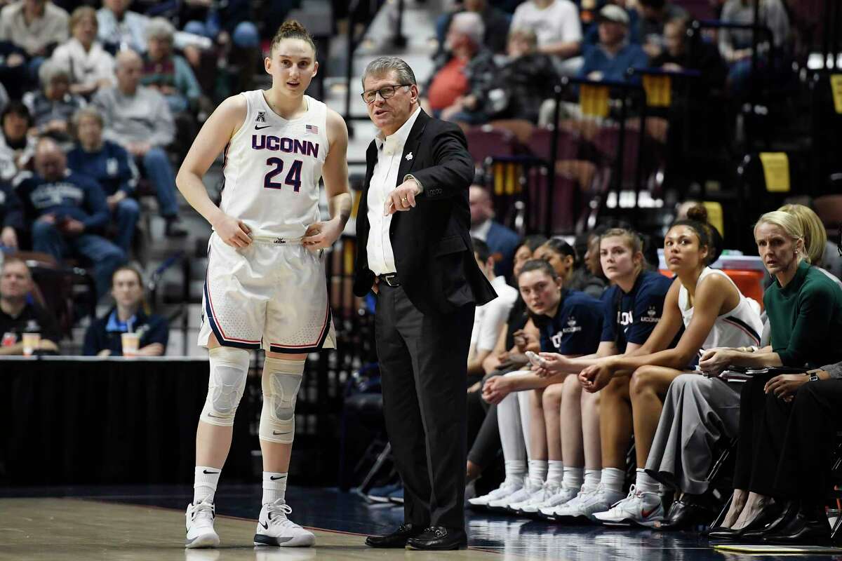 UConn coach Geno Auriemma talks with Anna Makurat (24) in the first half of the AAC quarterfinals at Mohegan Sun Arena.