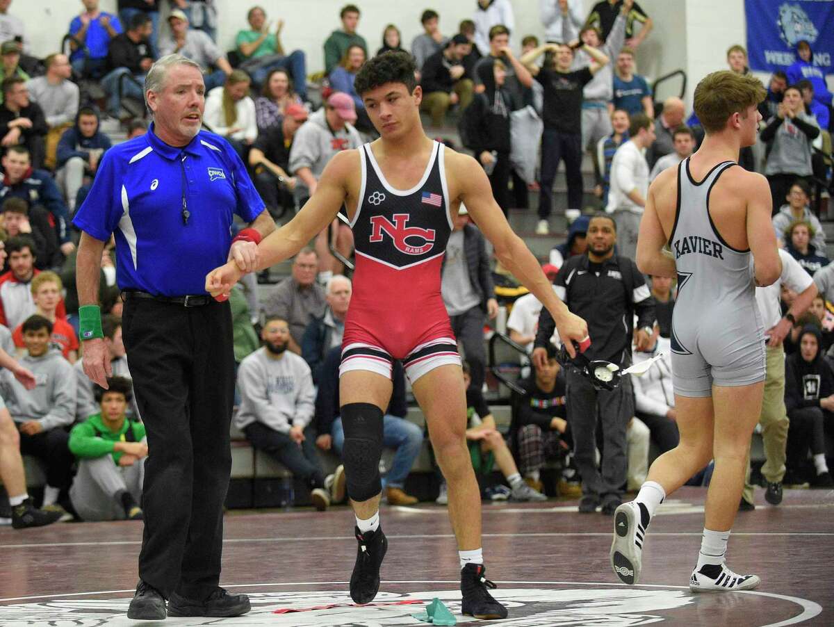 New Canaan's Tyler Sung pins Xavier's Quinn Moynihan to win the 152 pound weight class finals of the CIAC Class L Wrestling tournament on Feb. 22, 2020 at Bristol Central High School in Bristol, Connecticut.