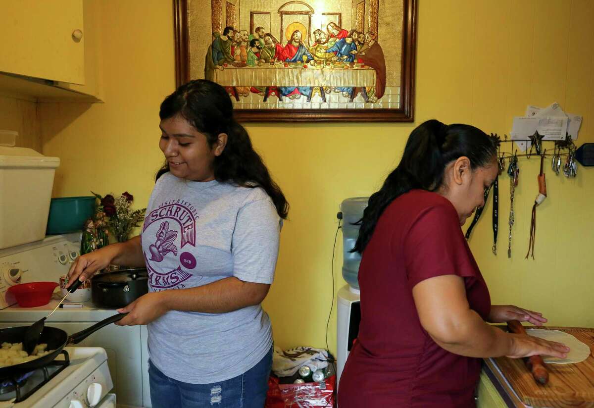 Dolores Venegas, right, and her daughter, Jacqueline Ricalday, 18, prepare breakfast at their home Thursday, March 19, 2020, in Houston. Ricalday, a senior at Northside High School, doesn't know when school and her internship at Texas Children's Hospital will resume, after both were halted due to the new coronavirus pandemic. She has also seen her hours at Marble Slab Creamery slashed because of the virus.