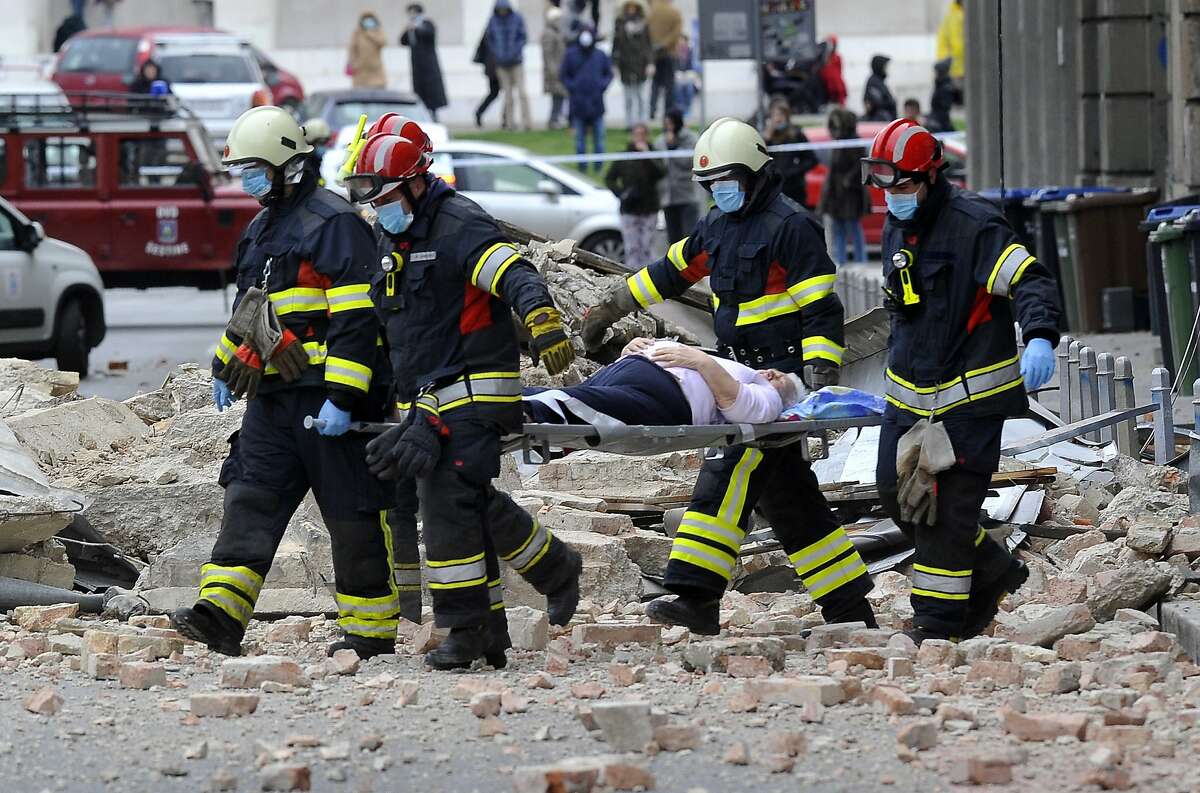 Firefighters carry a person on a stretcher after an earthquake in Zagreb, Croatia, Sunday, March 22, 2020. A strong earthquake shook Croatia and its capital on Sunday, causing widespread damage and panic. (AP Photo)