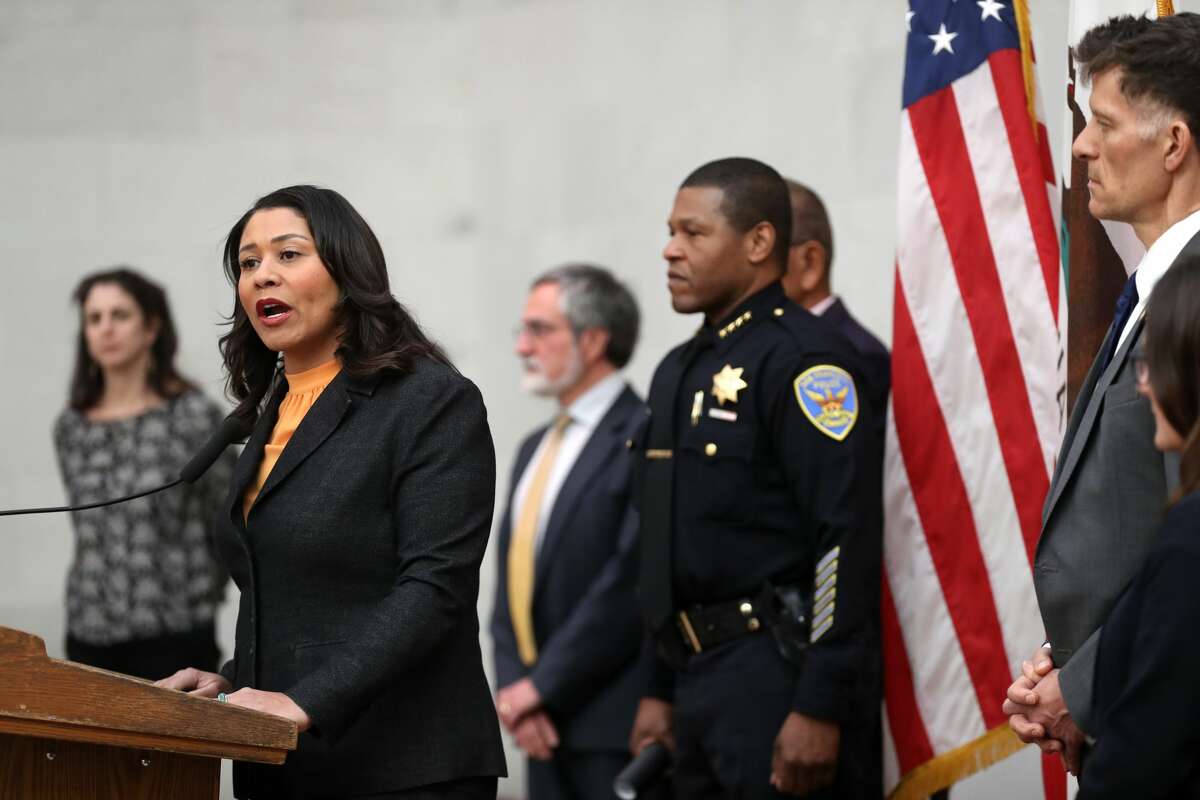 San Francisco Mayor London Breed (left) speaks during a press conference as San Francisco police chief William Scott (right) looks on at San Francisco City Hall on March 16, 2020 in San Francisco. Breed announced a shelter-in-place order for residents in San Francisco until April 7. The order will allow people to leave their homes to do essential tasks such as grocery shopping and pet walking.