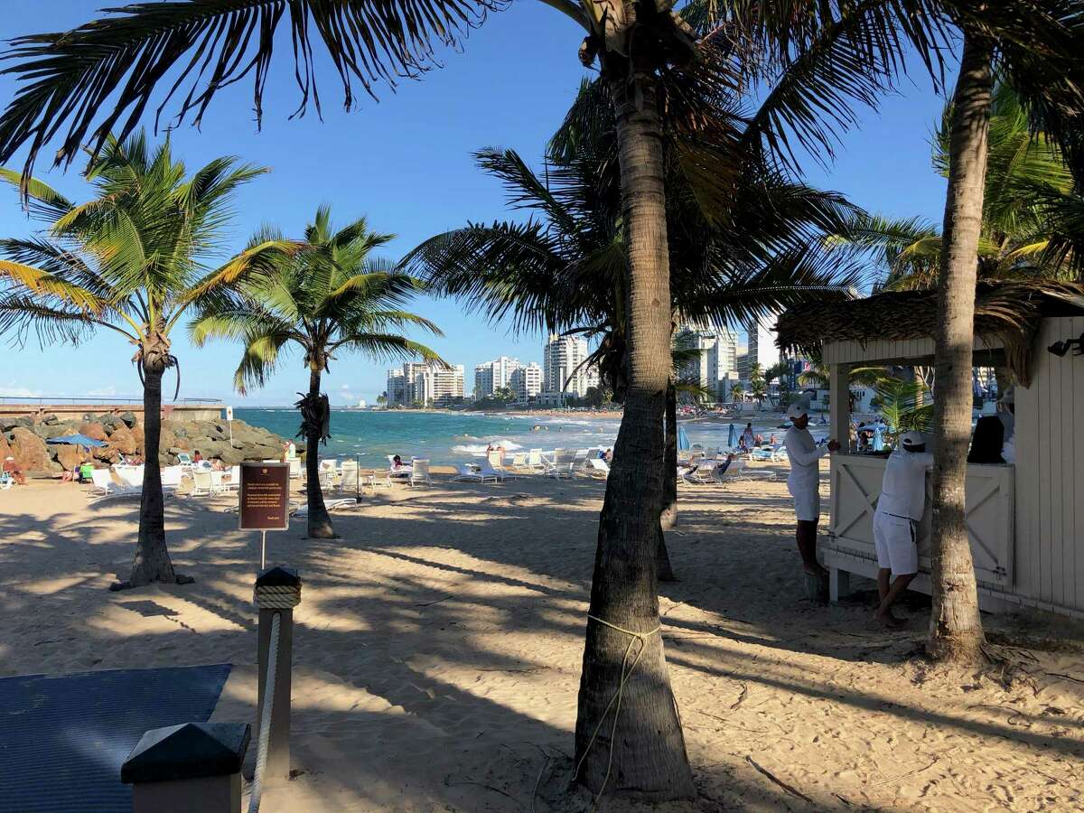 The beach at Condado in San Juan, not far from the Dreamcatcher Hotel and its communal kitchen, below. Bottom right, ceviche from Santisimo in Old San Juan.