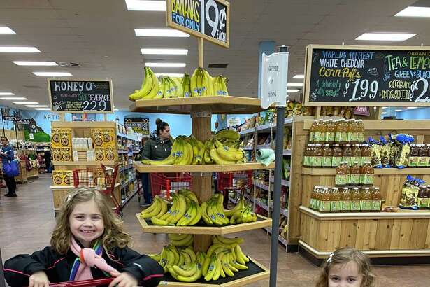 Chloe, left, and Lilly learn early at the supermarket.