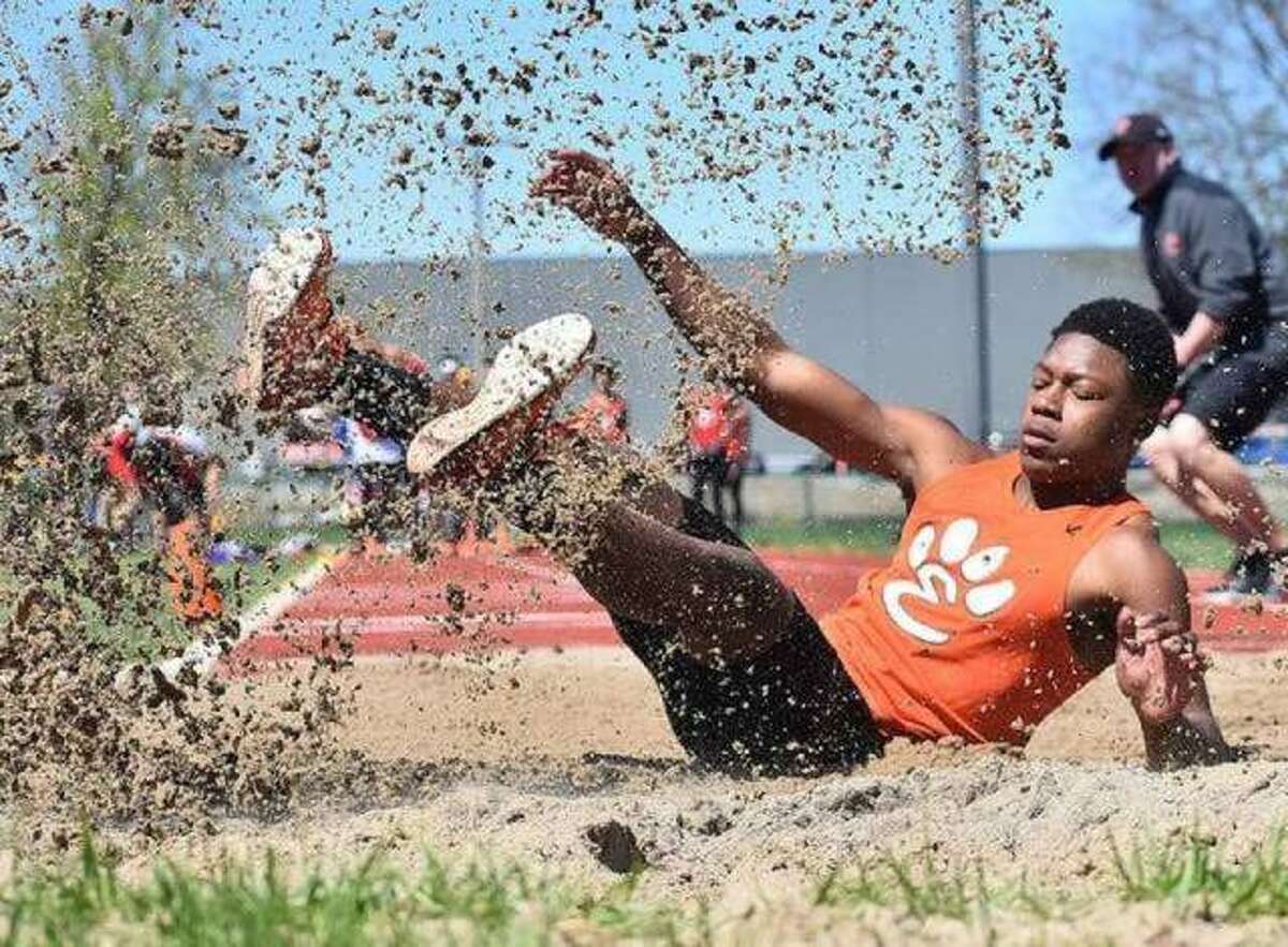 Edwardsville long jumper Kenyon Johnson lands after leaping 22-9 to finish second in the event at the Winston Brown Track and Field Invitational last season.