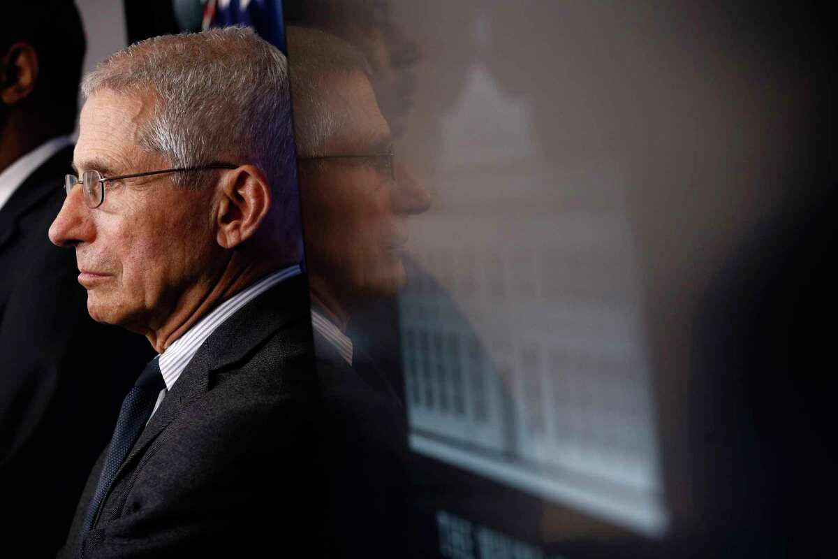 Director of the National Institute of Allergy and Infectious Diseases Dr. Anthony Fauci listens as President Donald Trump speaks during a coronavirus task force briefing at the White House, Saturday, March 21, 2020, in Washington.