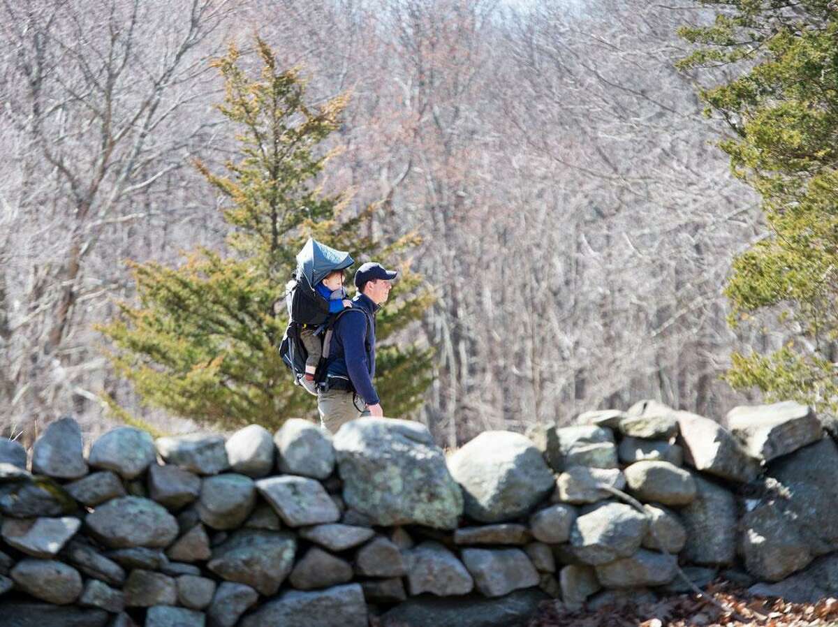 A man and child take a stroll at Weir Farm on Saturday, March 21.
