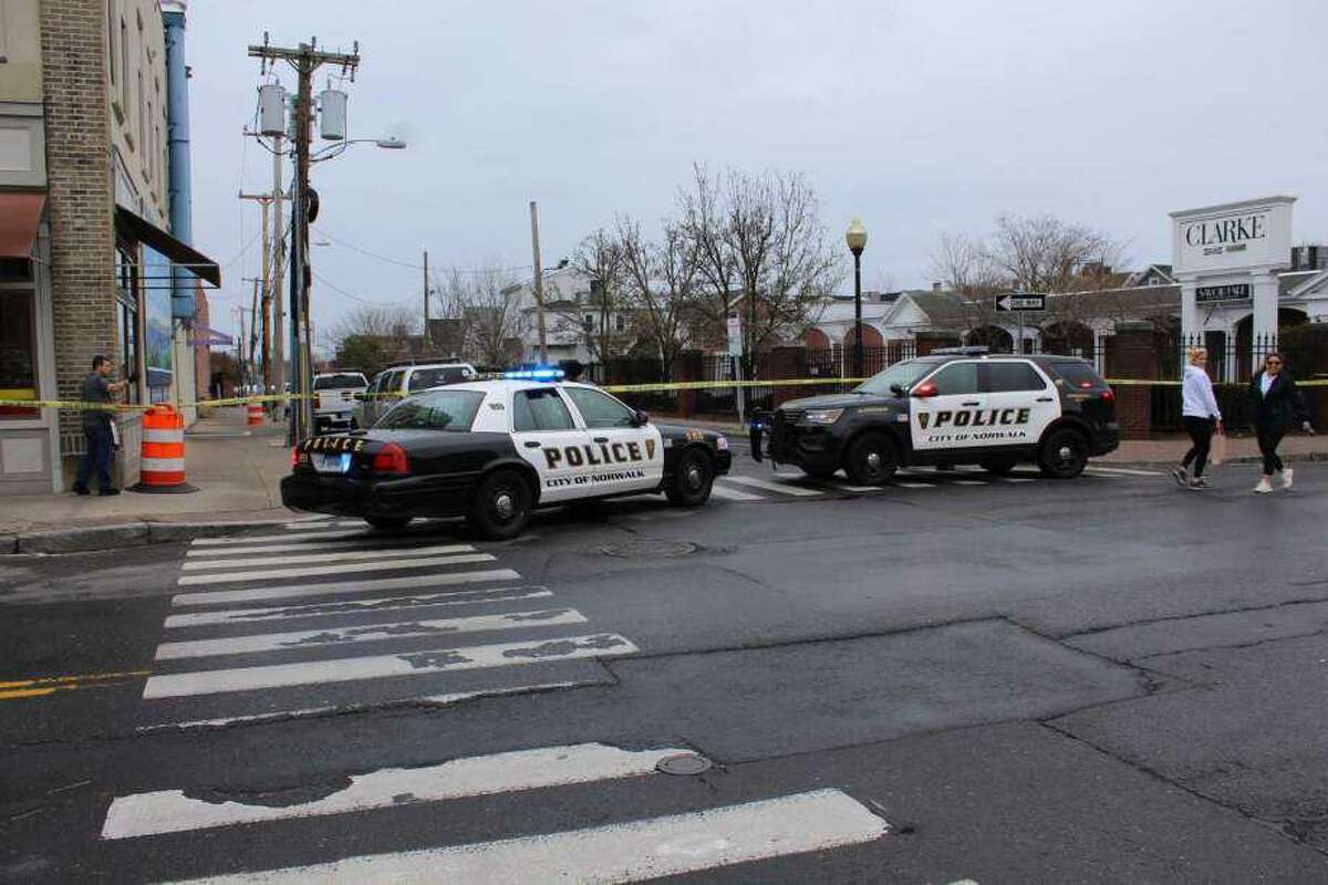 Police blocked off Elizabeth Street i Norwalk on Monday morning after three people were found dead in a garage.